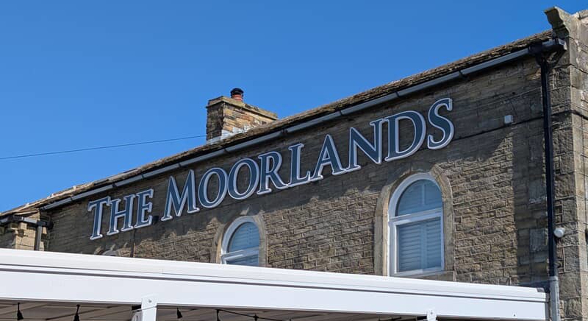 An image of The Moorlands signage at the top of the building.